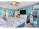 Bright bedroom with a ceiling fan, a large bed, closet, and a mounted television at 5077 Newpark Nw Dr, Acworth, GA 30101