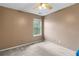Neutral bedroom showcasing natural light through a bright window and neutral carpet at 5077 Newpark Nw Dr, Acworth, GA 30101