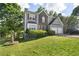 Two-story home with stone accents, a well-manicured lawn and a two-car garage at 5077 Newpark Nw Dr, Acworth, GA 30101