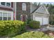 Close up of a beautiful house with a stone facade, attached garage and landscaped bushes along the walkway at 5077 Newpark Nw Dr, Acworth, GA 30101