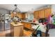 Functional kitchen featuring wood cabinets, an island, stainless steel appliances and tile backsplash at 5077 Newpark Nw Dr, Acworth, GA 30101