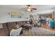 Open concept living room with a ceiling fan, and view into the kitchen and dining area at 5077 Newpark Nw Dr, Acworth, GA 30101