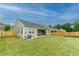 Spacious, well-maintained backyard with a fenced perimeter, lush grass, and a covered patio at 5344 Flat Rock Pt, Stonecrest, GA 30038