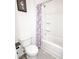 Bathroom showcasing a shower/tub with a purple shower curtain, white tiles, and toilet at 5344 Flat Rock Pt, Stonecrest, GA 30038