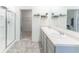 Bright bathroom featuring dual sinks, glass shower, and closet at 5344 Flat Rock Pt, Stonecrest, GA 30038