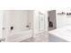 Modern bathroom with a tub, shower, and dual sinks at 5344 Flat Rock Pt, Stonecrest, GA 30038