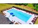 Community pool with lounge chairs and umbrellas for relaxing by the water at 5344 Flat Rock Pt, Stonecrest, GA 30038