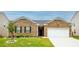 Charming single-story brick home with manicured lawn and attached two-car garage at 5344 Flat Rock Pt, Stonecrest, GA 30038