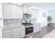 Kitchen with stainless steel microwave, gas range, and granite countertops at 5344 Flat Rock Pt, Stonecrest, GA 30038