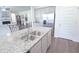 Spacious kitchen features granite island with dual sink and stainless steel refrigerator at 5344 Flat Rock Pt, Stonecrest, GA 30038