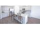Modern kitchen has gray cabinets, stainless appliances, and a large granite island at 5344 Flat Rock Pt, Stonecrest, GA 30038