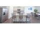 Modern kitchen with stainless appliances, large island and counter with chairs at 5344 Flat Rock Pt, Stonecrest, GA 30038