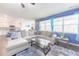 Bright living room features large sectional, modern rug, and plenty of natural light at 5344 Flat Rock Pt, Stonecrest, GA 30038