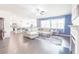 Spacious living room connecting to the kitchen with hardwood floors and comfortable furnishings at 5344 Flat Rock Pt, Stonecrest, GA 30038