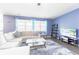 Sun-filled living room complete with a large sectional and mounted television at 5344 Flat Rock Pt, Stonecrest, GA 30038