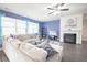 Cozy living room with a fireplace, hardwood floors, and ample natural light from large windows at 5344 Flat Rock Pt, Stonecrest, GA 30038