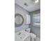 Bathroom includes a modern sink, large vanity mirror, medicine cabinet, and window at 1615 Arden Sw Dr, Marietta, GA 30008