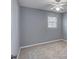 Neutral carpeted bedroom offers a ceiling fan and a large window, providing ample natural light at 1615 Arden Sw Dr, Marietta, GA 30008