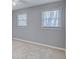 Large windows illuminate the bedroom with neutral carpet and wall color at 1615 Arden Sw Dr, Marietta, GA 30008