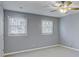 Bedroom featuring neutral paint, carpet, and two windows at 1615 Arden Sw Dr, Marietta, GA 30008