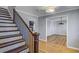 Hardwood staircase leading to an open doorway, revealing a room with a fireplace at 1615 Arden Sw Dr, Marietta, GA 30008