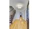 Spacious foyer with hardwood floors, a staircase, and a view into the living area at 1615 Arden Sw Dr, Marietta, GA 30008
