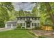 Beautiful two-story house with a well-manicured lawn and a two-car garage, surrounded by mature trees at 1615 Arden Sw Dr, Marietta, GA 30008