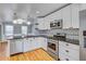 Updated kitchen with white cabinets, stainless steel appliances, and hardwood floors at 1615 Arden Sw Dr, Marietta, GA 30008