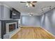 Bright living room with hardwood floors, fireplace, ceiling fans, and track lighting at 1615 Arden Sw Dr, Marietta, GA 30008