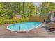 Inviting pool with wooden surround and dining area nestled among trees, perfect for relaxation and outdoor enjoyment at 1615 Arden Sw Dr, Marietta, GA 30008