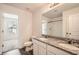 Elegant bathroom featuring double sinks, granite countertops, and a view into the bedroom at 33 Oxford Ln, Kingston, GA 30145
