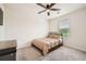 Bright bedroom featuring a ceiling fan, a large window, and neutral carpet at 33 Oxford Ln, Kingston, GA 30145