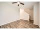 Bright bedroom with modern flooring leading to stairway, illuminated by a ceiling fan at 33 Oxford Ln, Kingston, GA 30145
