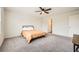 Spacious bedroom with ceiling fan and plush carpet, offering a serene and inviting atmosphere at 33 Oxford Ln, Kingston, GA 30145