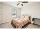 Bedroom featuring a ceiling fan, window, and plush carpet, creating a comfortable retreat at 33 Oxford Ln, Kingston, GA 30145