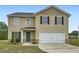 Charming two-story home featuring a garage, manicured lawn, and appealing curb appeal at 33 Oxford Ln, Kingston, GA 30145