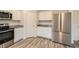 Modern kitchen boasts stainless steel appliances, white cabinets, and granite countertops at 33 Oxford Ln, Kingston, GA 30145