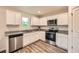 Bright kitchen offers granite countertops, stainless appliances, and white cabinets at 33 Oxford Ln, Kingston, GA 30145