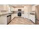 A modern kitchen features granite counters, stainless appliances, and white cabinets at 33 Oxford Ln, Kingston, GA 30145
