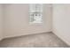 Carpeted walk-in closet with a wire rack and window for organization and natural light at 33 Oxford Ln, Kingston, GA 30145