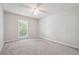 Bedroom with neutral walls, gray carpet and a window with natural light at 3335 New Heritage Dr, Alpharetta, GA 30022