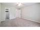 Bedroom features neutral walls, gray carpet, two closets and a ceiling fan at 3335 New Heritage Dr, Alpharetta, GA 30022