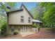 Back exterior view showcasing the home's unique architectural details and backyard patio at 3335 New Heritage Dr, Alpharetta, GA 30022