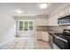 Bright kitchen featuring sleek appliances, ample counter space, and large picture window at 3335 New Heritage Dr, Alpharetta, GA 30022