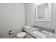 Stylish powder room features a granite countertop, framed mirror, and neutral color palette at 3335 New Heritage Dr, Alpharetta, GA 30022
