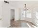 Bright dining area with neutral walls, modern chandelier, and large windows at 3775 Reston Ln, Decatur, GA 30034