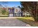 Charming two-story home with red shutters, attached garage, and cozy front yard on a sunny day at 3775 Reston Ln, Decatur, GA 30034