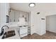 White kitchen featuring modern stainless steel appliances, countertops, and ample cabinet space at 3775 Reston Ln, Decatur, GA 30034