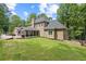 Well-maintained backyard featuring a screened-in porch, a deck, a grill, and a spacious lawn perfect for outdoor activities at 9950 Farmbrook Ln, Johns Creek, GA 30022