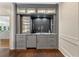 Stylish gray bar area featuring granite countertops, wine rack, and subway tile backsplash at 9950 Farmbrook Ln, Johns Creek, GA 30022